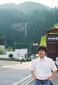 [Photo: Tamura in front of Nachi waterfall: 2003. 7.26]